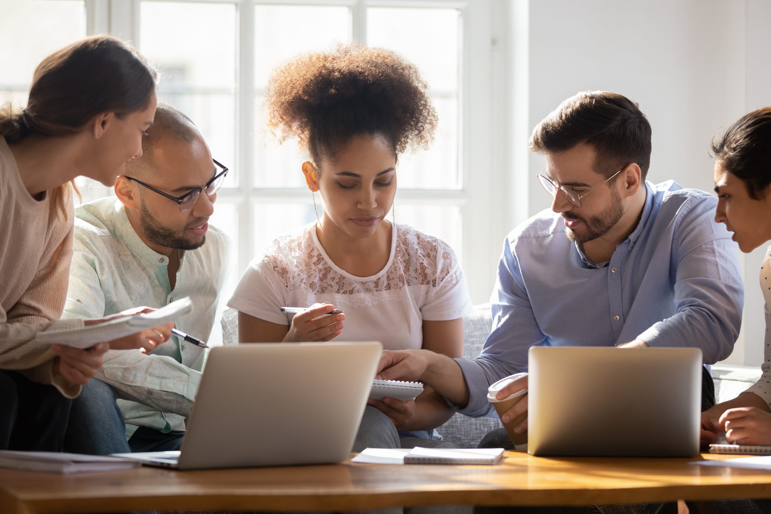 A group of employees brainstorm on a project together.